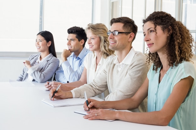 Casual business team listening during meeting