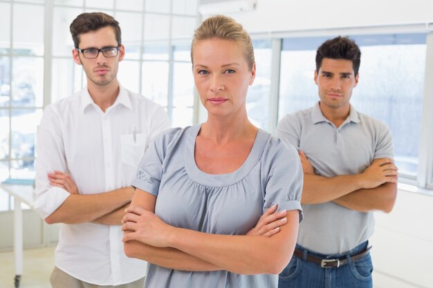 Casual business team looking at camera with arms crossed