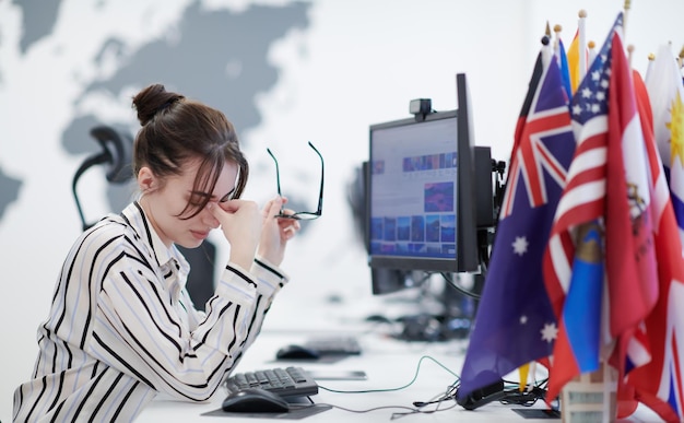 Casual business woman working on desktop computer in modern\
open plan startup office interior