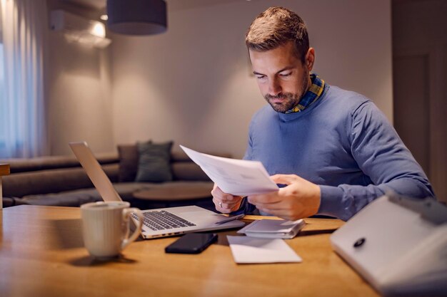 A casual businessman doing paperwork and working from home