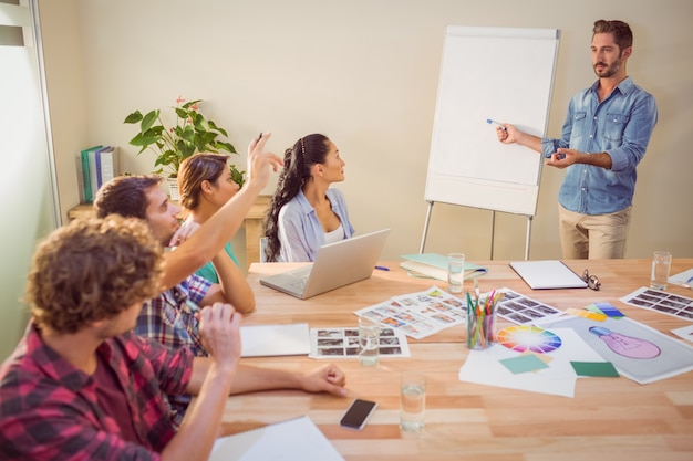 Casual businessman giving presentation to his colleagues