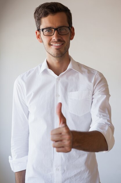 Casual businessman giving thumbs up to camera