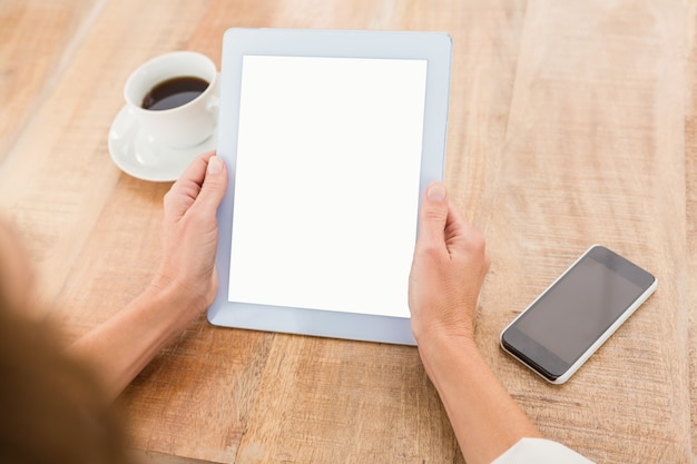 Casual businessman holding blank screen tablet