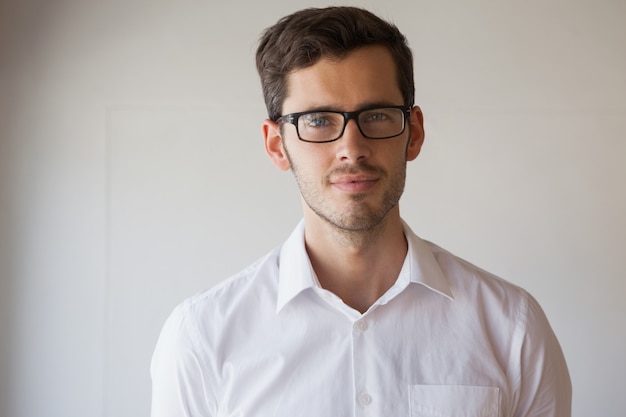 Casual businessman smiling at camera wearing glasses