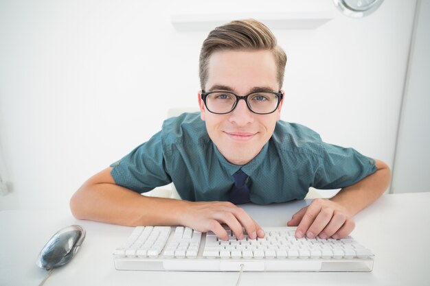 Casual businessman typing at his desk