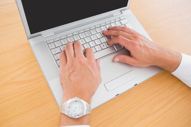 Casual businessman using his laptop 