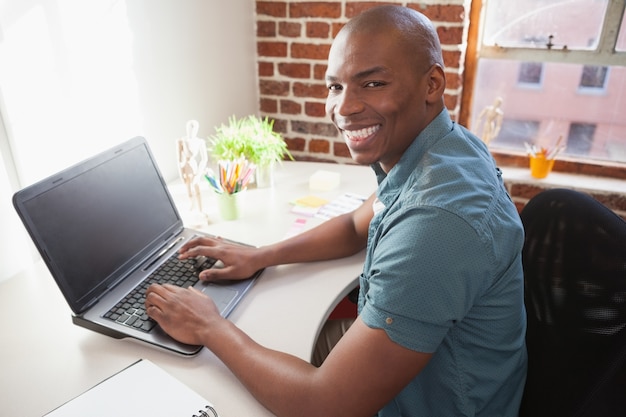 Casual businessman working on laptop at desk