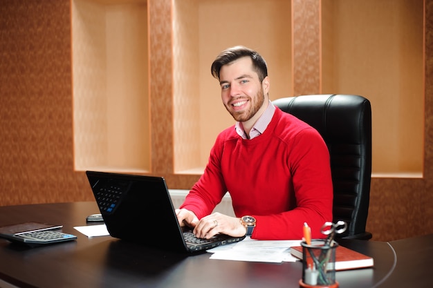 Casual businessman working with computer in office