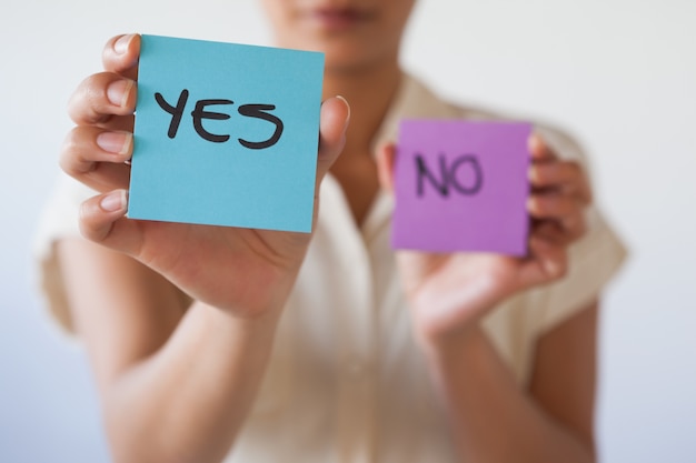 Casual businesswoman showing yes card