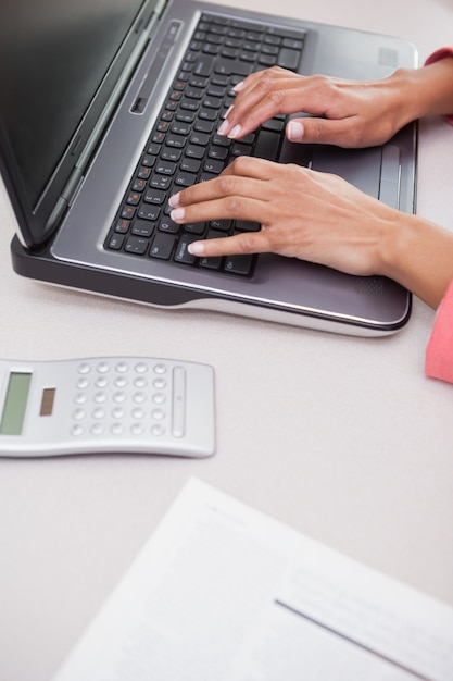 Casual businesswoman typing on laptop