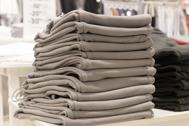 Casual clothes closeup A stack of trousers Textile industry