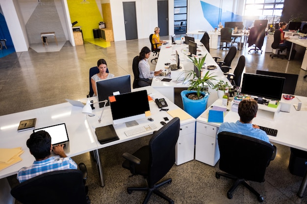 Casual colleagues using computers at office