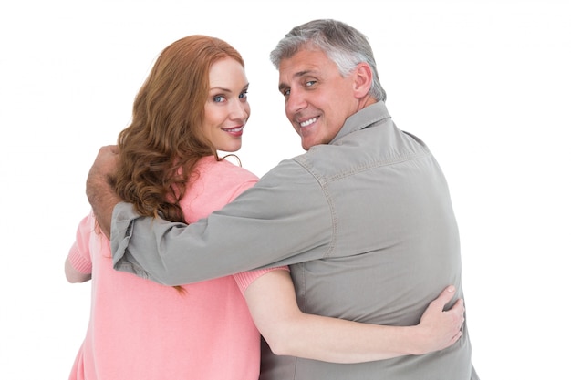 Casual couple standing arms around