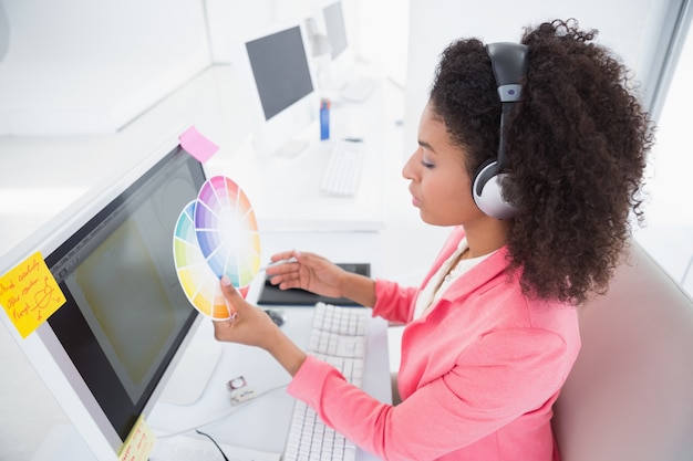 Casual graphic designer working at her desk