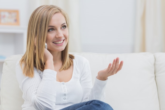 Casual happy woman using cellphone at home