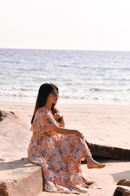 Young Woman on Black T-shirt, Fashion Sunglasses and Blue Jeans Stand on  the Beach, Looking at the Sea. Girl Doing Sunbath on Stock Image - Image of  resting, beauty: 185036683