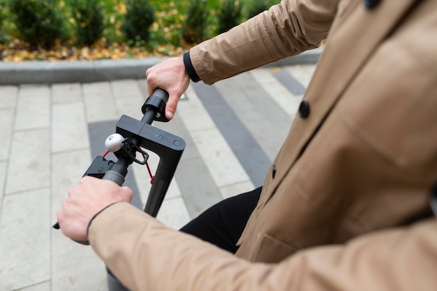 Casual male riding his scooter outdoors