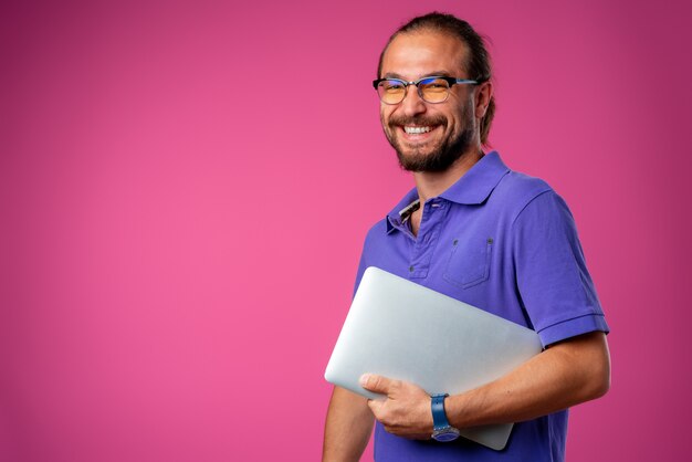 Casual man in glasses standing with laptop