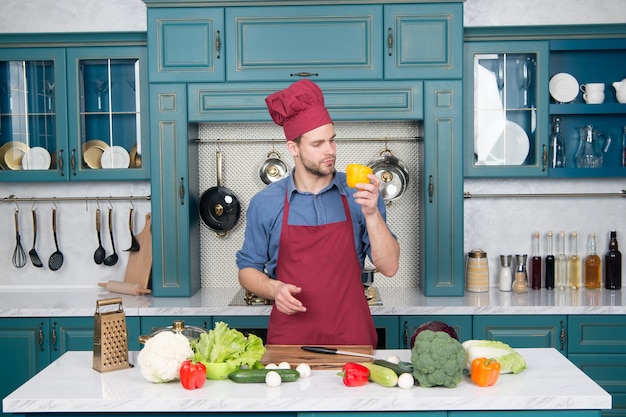 Casual man preparing salad at home