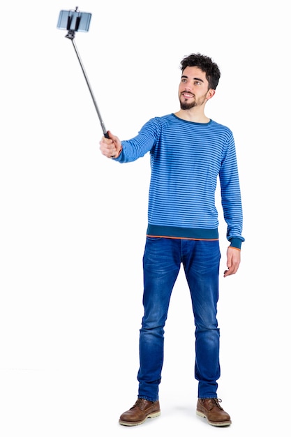 Casual man using a selfie stick