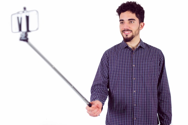 Casual man using a selfie stick