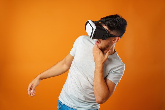 Casual man in white t-shirt wearing VR glasses