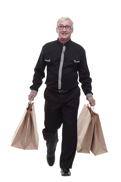 Casual man with shopping bags striding forward