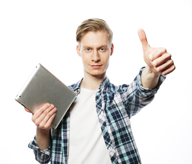 Casual man with tablet pad computer making the ok thumbs up hand sign