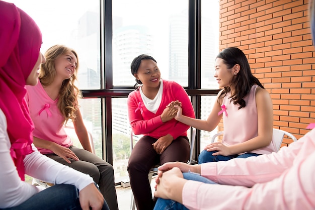 Casual multiethinic women sitting in circle in the meeting 