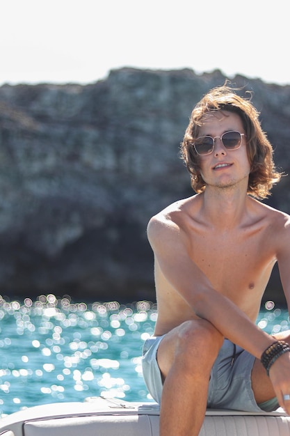 Casual portrait of man on Luxury yacht deck relaxing on summer vacation trip