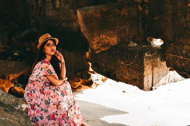 casual pretty girl front pose sitting on beach indian pakistani model