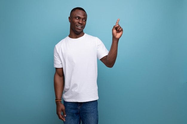 Casual s african man with short haircut in white tank top pointing finger to the side