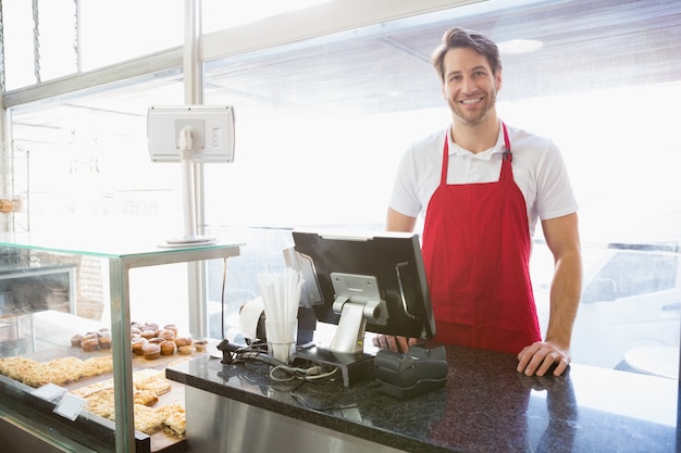 Casual server posing behind the counter