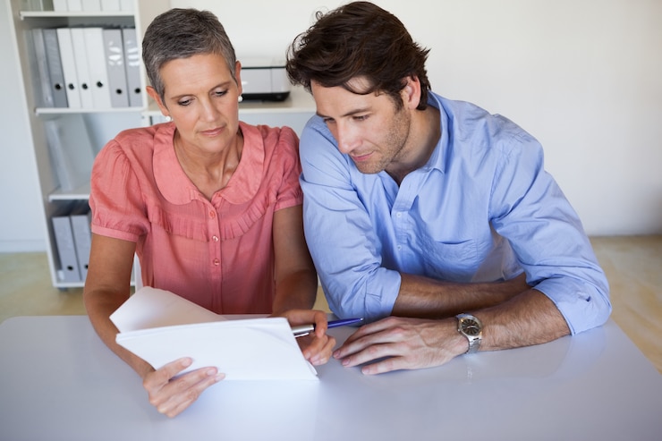 People reviewing a n insurance form 