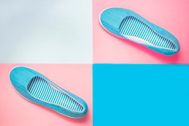 Casual summer footwear on pink and blue background. Women or teenage fashion