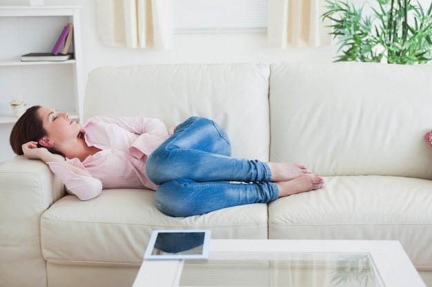 Casual woman resting on couch at home