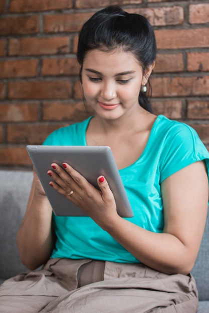 Casual woman using tablet at home