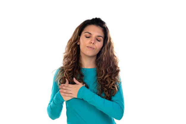 Casual woman with wavy and long hair isolated on a white wall