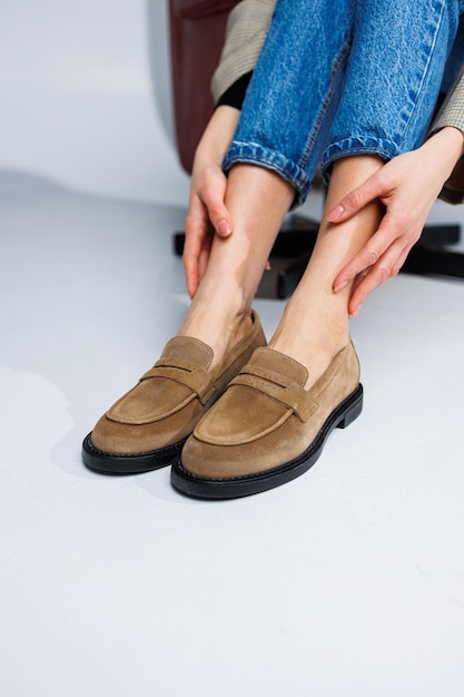 Casual women's fashion Classic shoes for women Slender female legs in trousers and brown stylish casual loafers Women's comfortable summer shoes