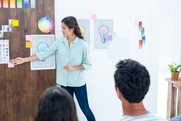 Casual young businessman giving presentation to colleagues 