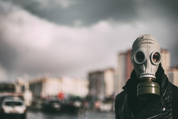 Casual young man in a gas mask looking at the camera