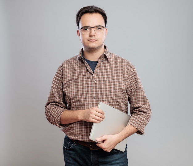 Casual young man in shirt with laptop