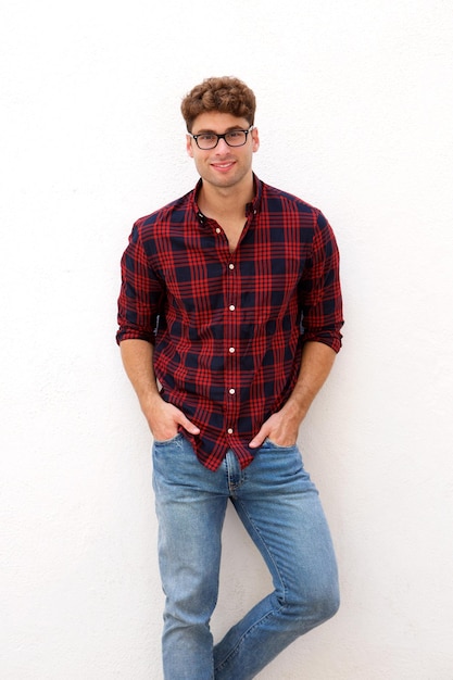 Casual young man with glasses standing and smiling