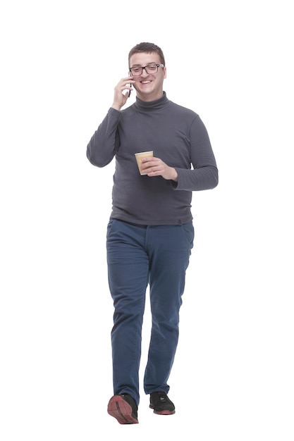 Casual young man with smartphone and takeaway coffee