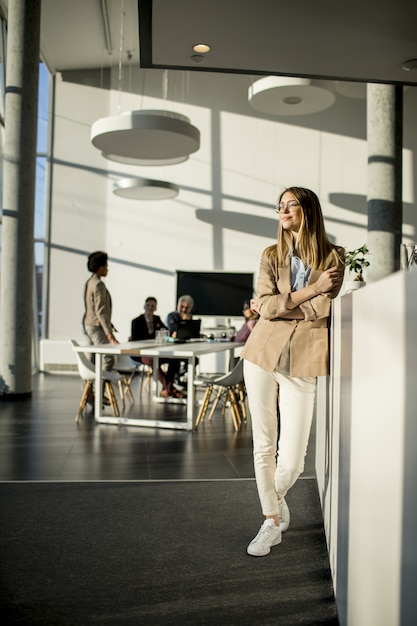 Casual young woman in a busy modern workplace