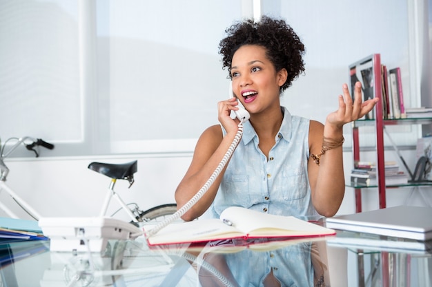 Casual young woman using telephone