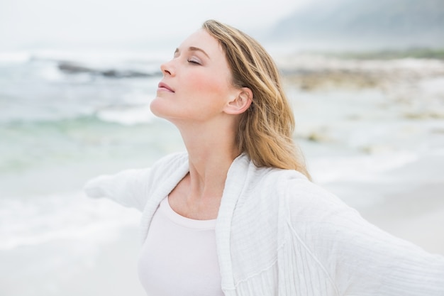 Casual young woman with eyes closed at beach