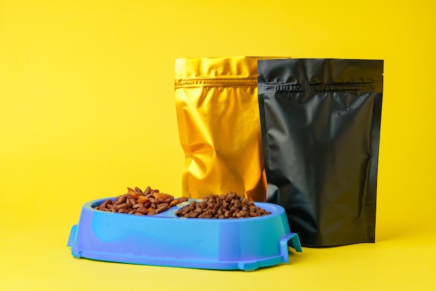 Cat food on yellow background studio shot