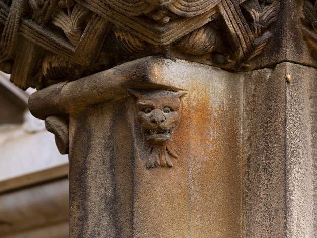 A cat head carved into a column