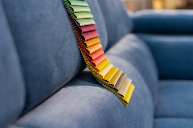 Photo catalog of multi-colored fabric samples on sofa